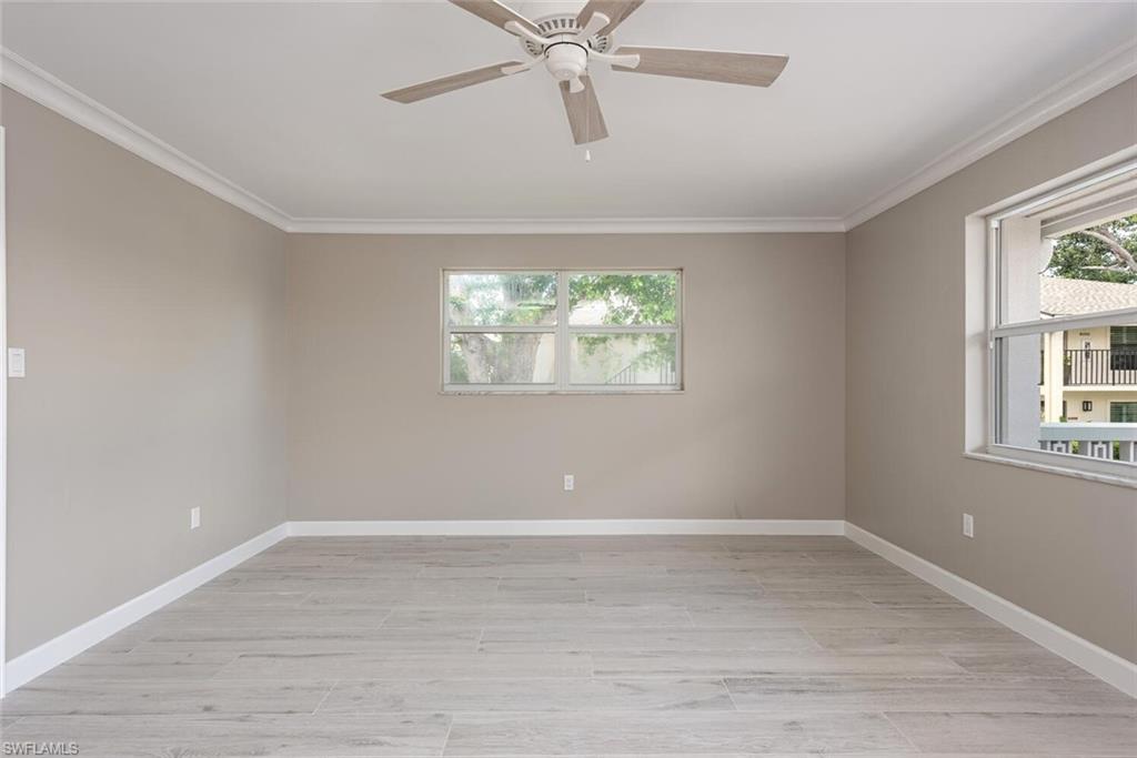 780 10th Avenue South, Unit 23 Naples, FL 34102 - Photo 8 of 15 wooden floor in an empty room with a window