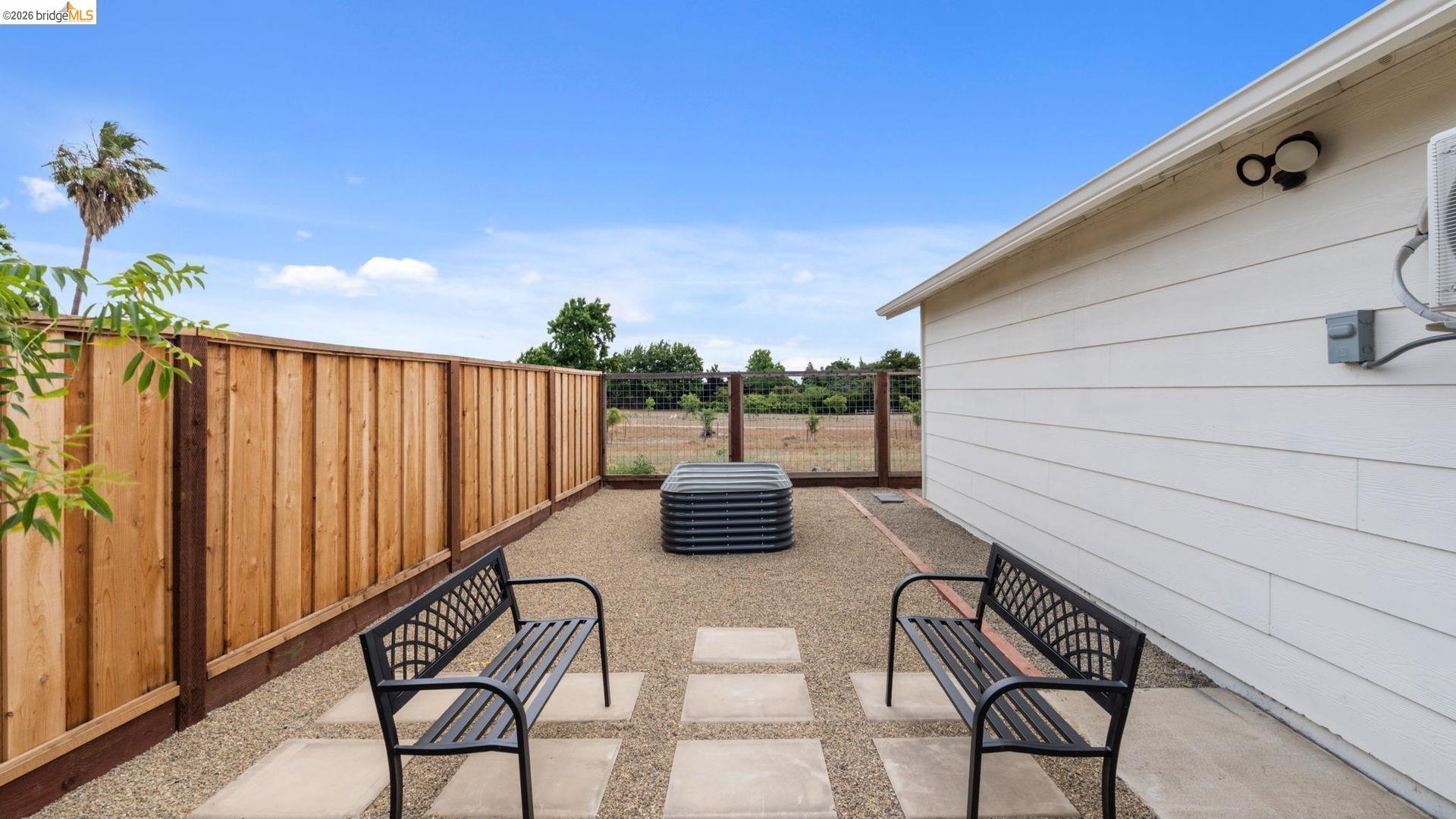 700 Brownstone Road Oakley, CA 94561 - Photo 42 of 58 Gravel patio space featuring concrete stepping stones and a wooden privacy fence
