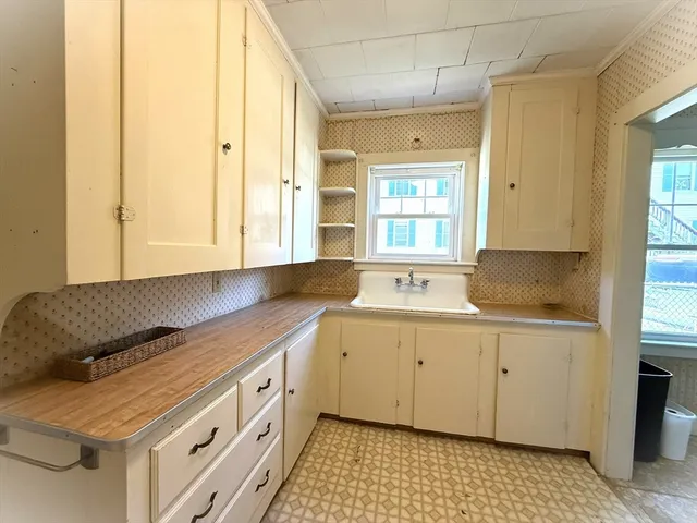 a kitchen with a sink stove and cabinets