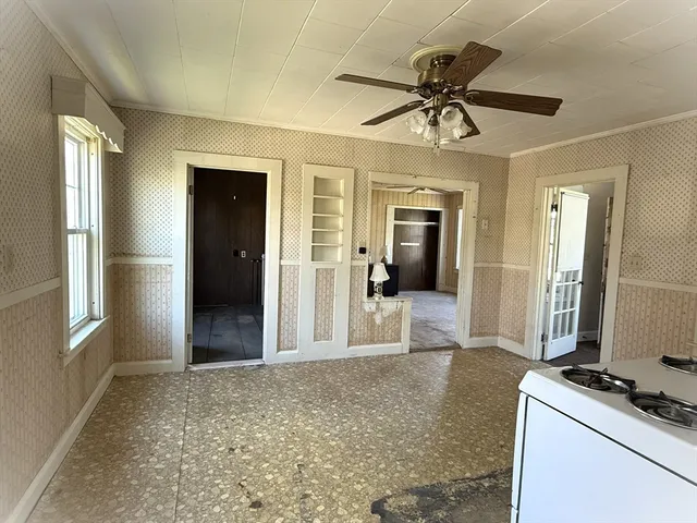 a view of a livingroom with a kitchen and a stove