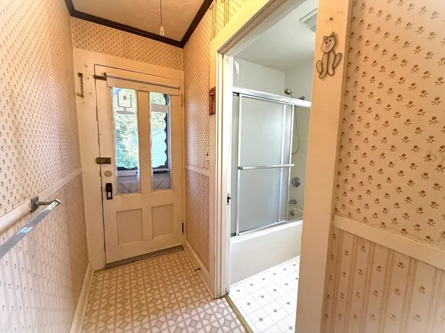 a bathroom with a granite countertop sink a mirror and shower