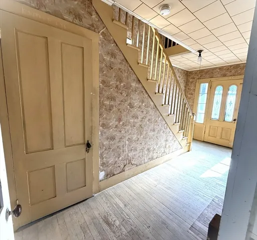 a view of an entryway with wooden floor