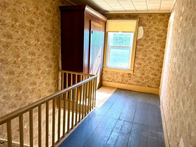 a view of a porch with wooden floor and door