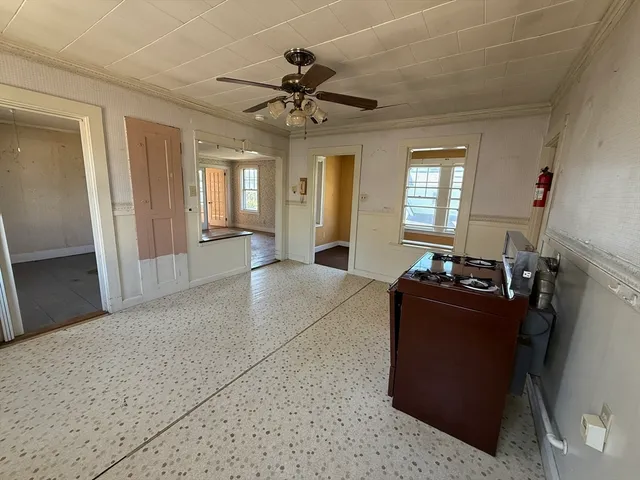 a living room with furniture windows and a flat screen tv