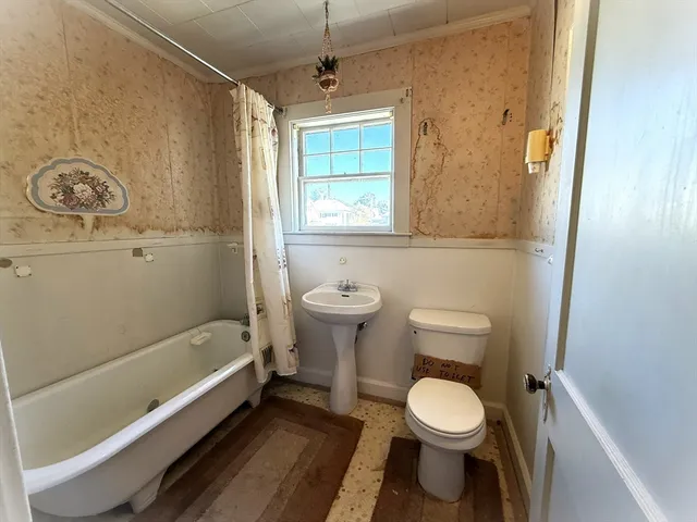 a bathroom with a toilet a sink and a bathtub