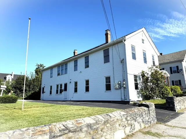 a view of a house with backyard and sitting area