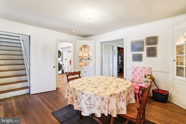 a bedroom with a bed and a dresser with rug