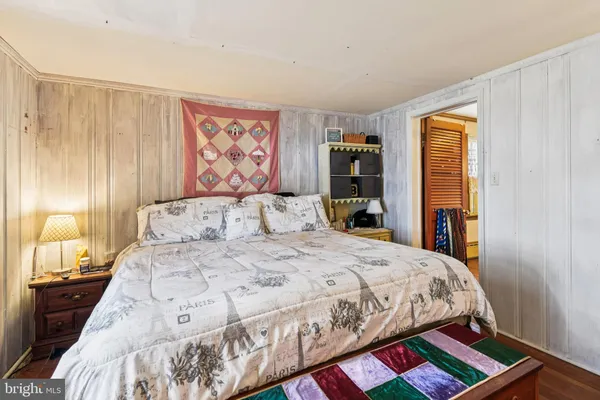 a bedroom with a large bed couch and a dresser