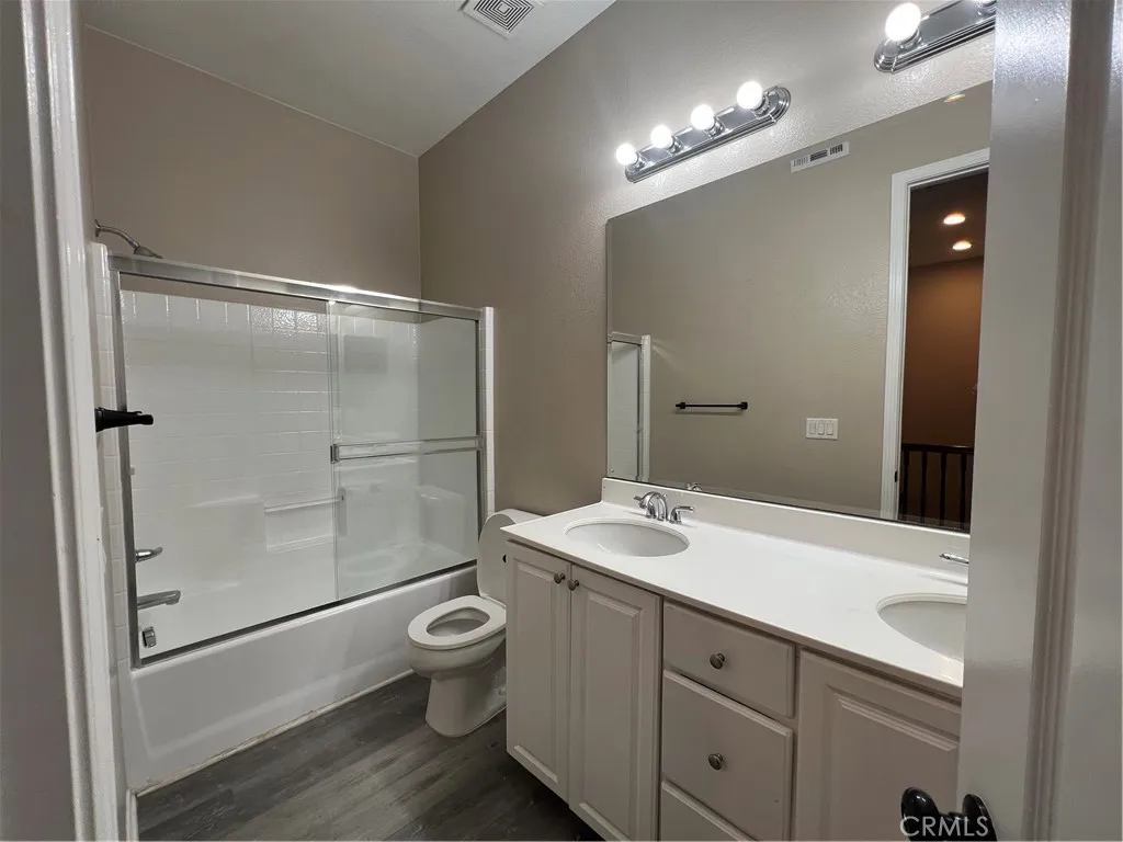 7161 East Avenue, Unit 104 Rancho Cucamonga, CA 91730 - Photo 11 of 18 a bathroom with a shower sink vanity mirror and toilet