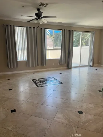 a view of a big room with windows and closet