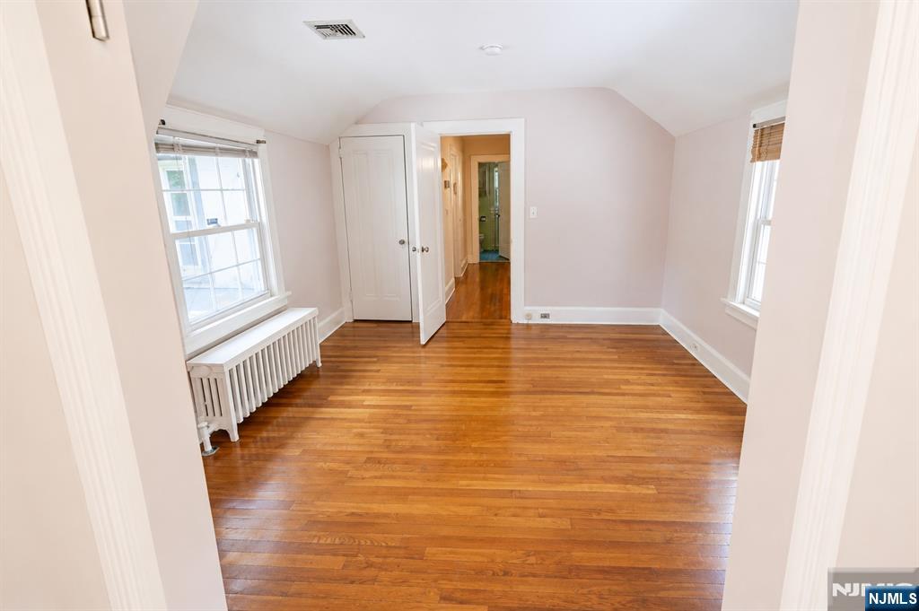298 Audubon Road Englewood, NJ 07631 - Photo 13 of 19 a view of an empty room with wooden floor and a window