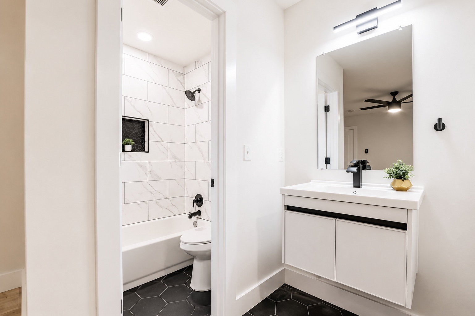 7500 Rio Pass Austin, TX 78724 - Photo 9 of 15 Contrasting dark hexagonal tile floors meet crisp white walls in this modern bath space.