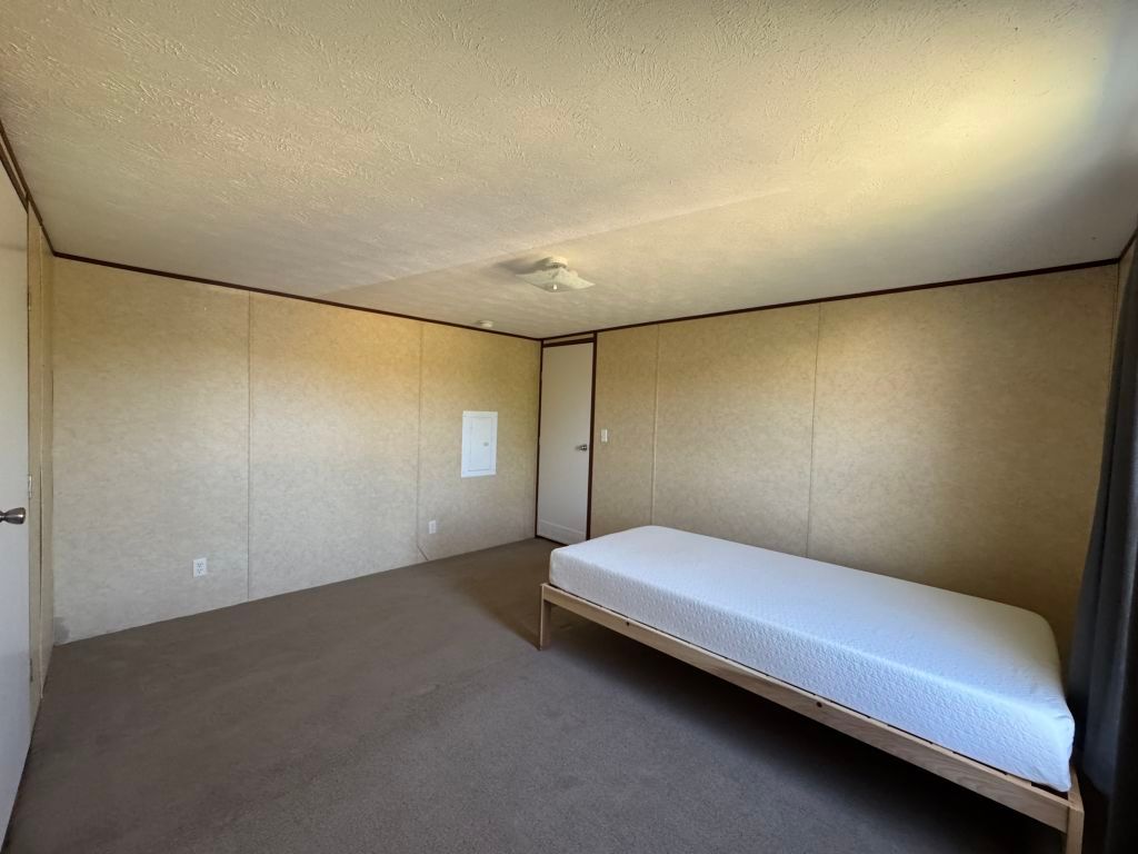 538 Cottle Town Road Smithville, TX 78957 - Photo 13 of 38 a bedroom with a bed and a wall painting