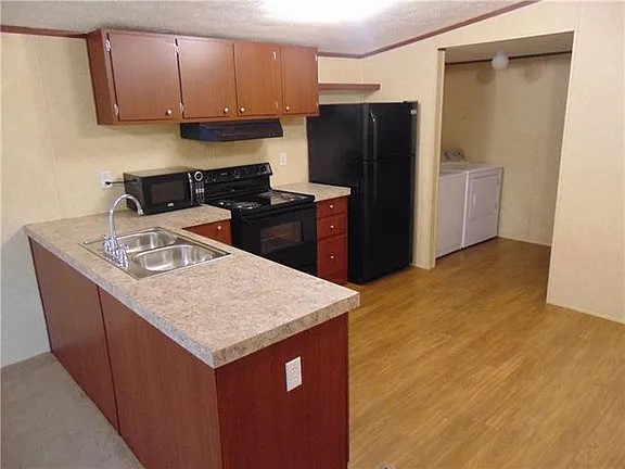 538 Cottle Town Road Smithville, TX 78957 - Photo 7 of 38 a kitchen with stainless steel appliances granite countertop a refrigerator a sink a stove and dishwasher