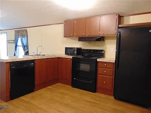 538 Cottle Town Road Smithville, TX 78957 - Photo 8 of 38 a kitchen with a stove and a refrigerator