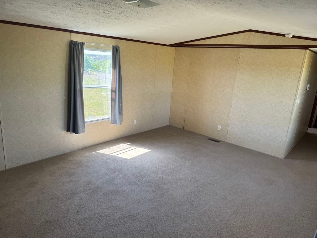 538 Cottle Town Road Smithville, TX 78957 - Photo 9 of 38 an empty room with a empty space and a window