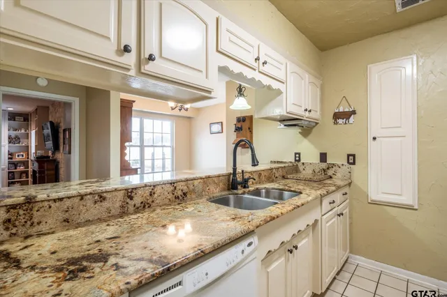 a kitchen with stainless steel appliances granite countertop a stove and a refrigerator