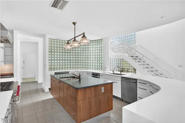 a kitchen with a sink stove and cabinets