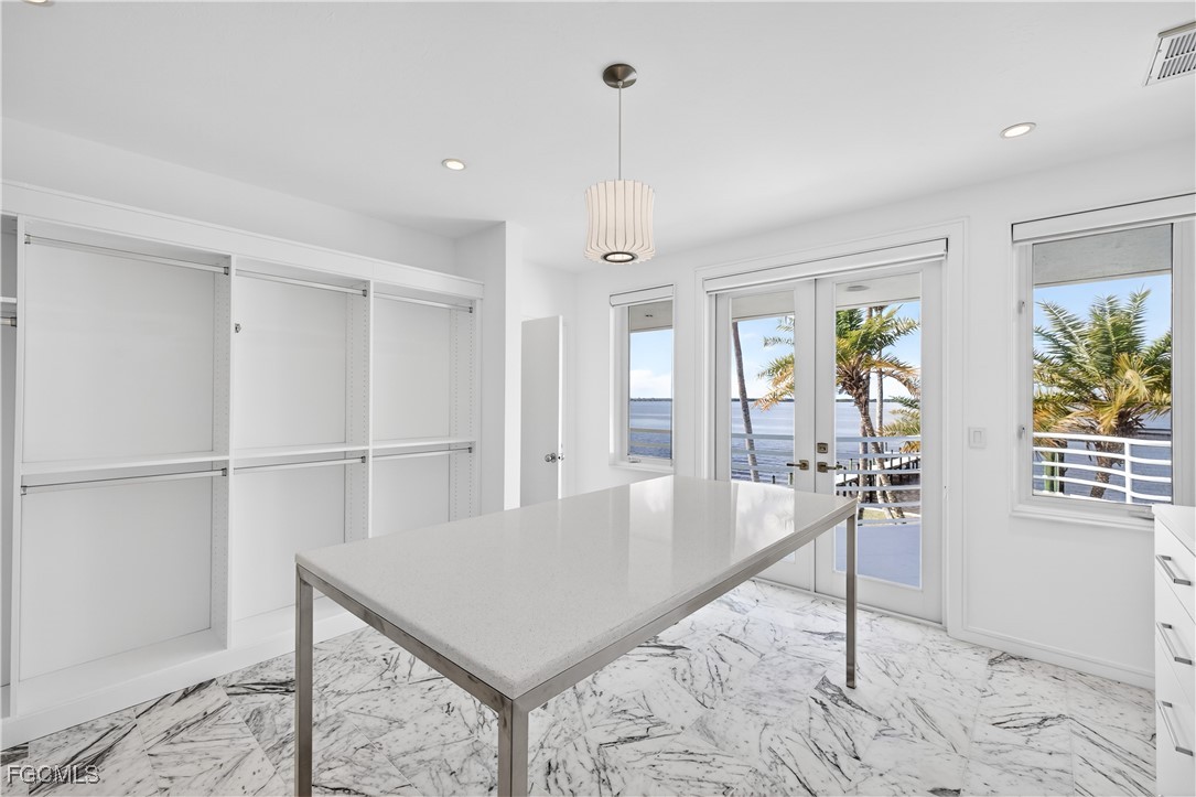 3402 West Riverside Drive Fort Myers, FL 33901 - Photo 25 of 50 a living room with furniture a chandelier and a table