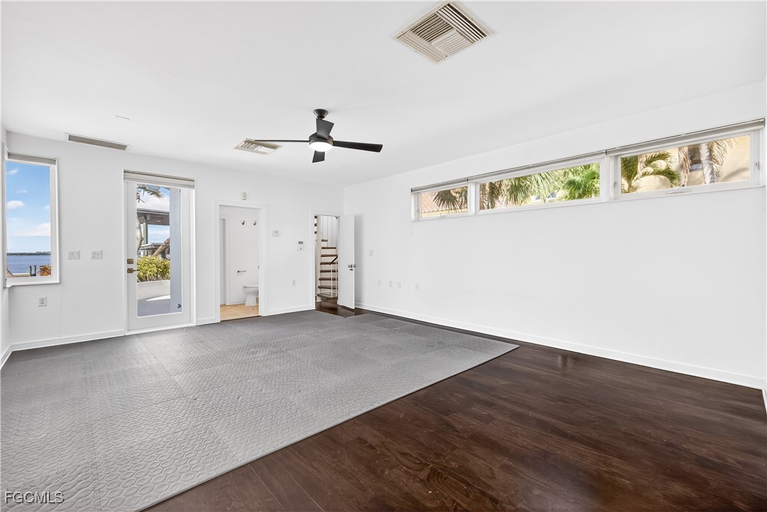 3402 West Riverside Drive Fort Myers, FL 33901 - Photo 40 of 50 an empty room with wooden floor and windows