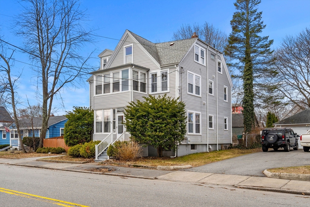 76 Myrtle Street Lynn, MA 01905 - Photo 1 of 27 a front view of a house with a garden