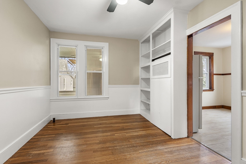 76 Myrtle Street Lynn, MA 01905 - Photo 14 of 27 a view of an empty room with wooden floor and a window