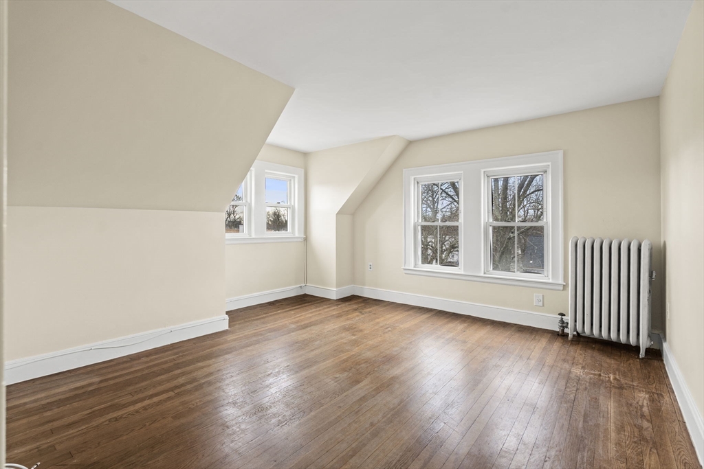 76 Myrtle Street Lynn, MA 01905 - Photo 19 of 27 an empty room with wooden floor and windows