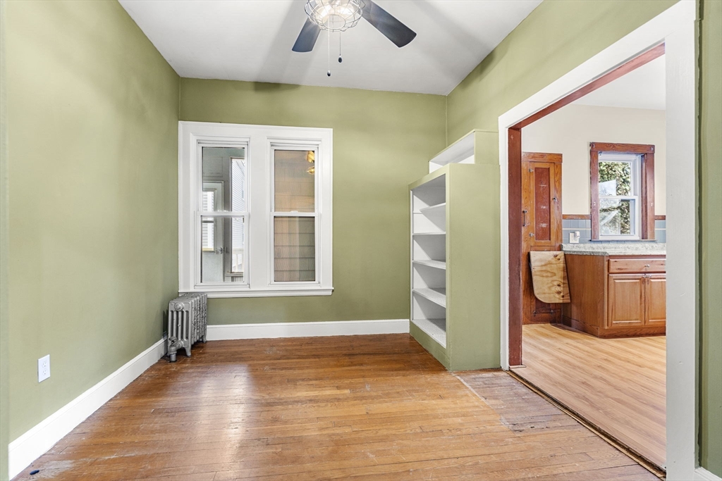 76 Myrtle Street Lynn, MA 01905 - Photo 6 of 27 a view of an empty room with window and wooden floor