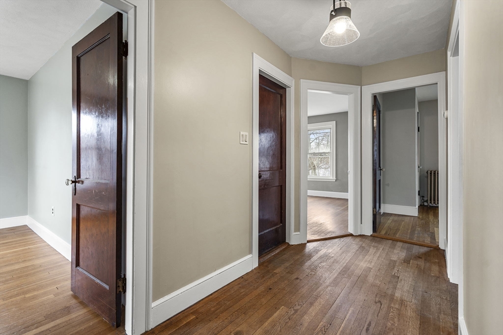 76 Myrtle Street Lynn, MA 01905 - Photo 9 of 27 an empty room with closet and wooden floor