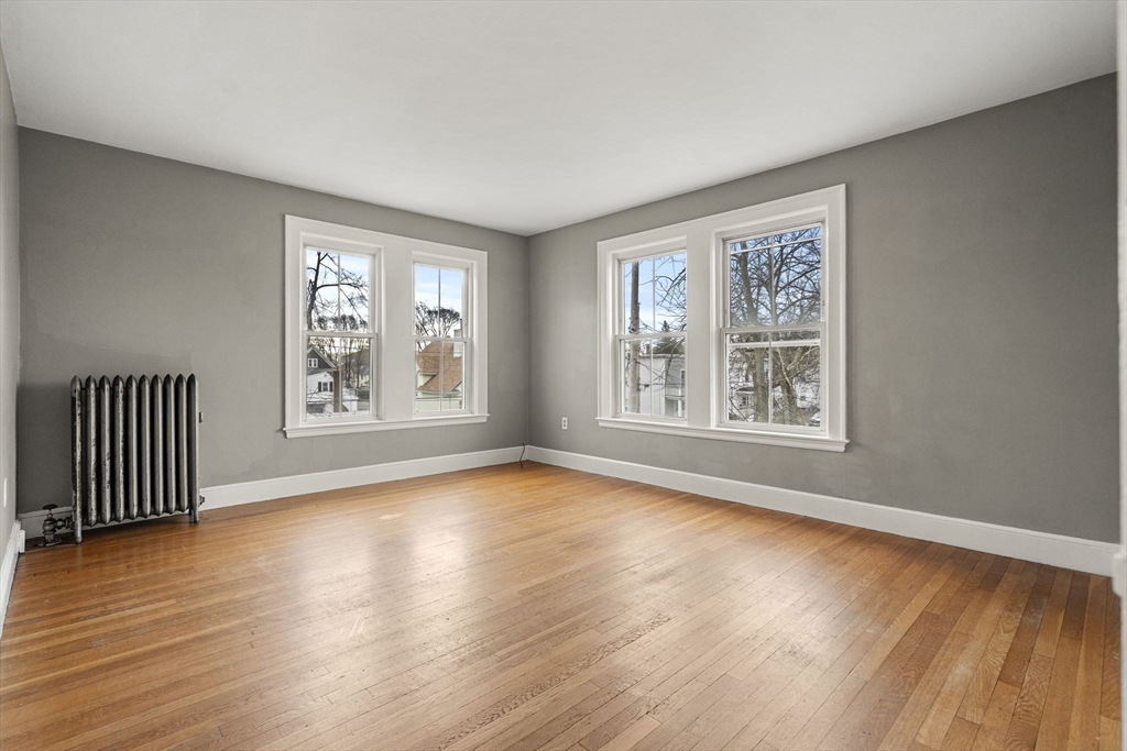 76 Myrtle Street Lynn, MA 01905 - Photo 10 of 27 a view of an empty room with wooden floor and a window