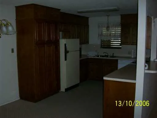 a kitchen with a refrigerator and a stove