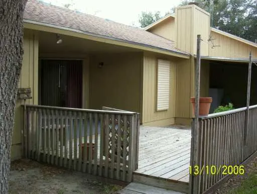 a view of a house with a wooden deck