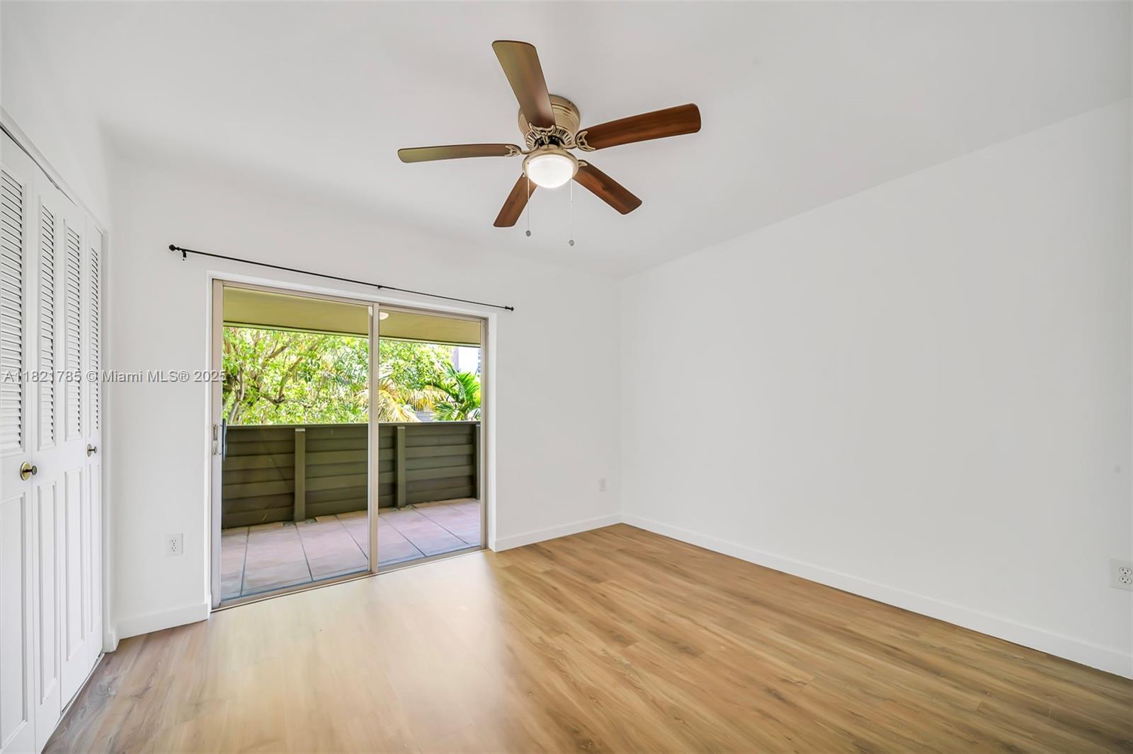 8335 Southwest 72nd Avenue, Unit 315D Miami, FL 33143 - Photo 15 of 28 a view of empty room with wooden floor and fan