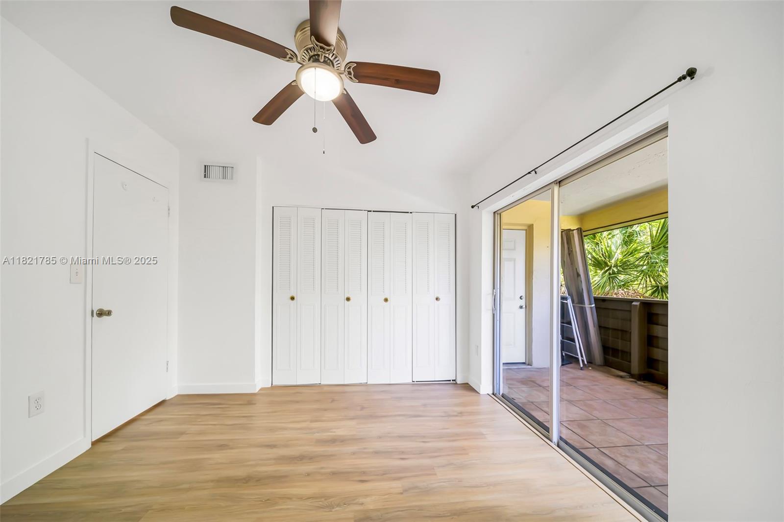 8335 Southwest 72nd Avenue, Unit 315D Miami, FL 33143 - Photo 17 of 28 a view of empty room with wooden floor and fan