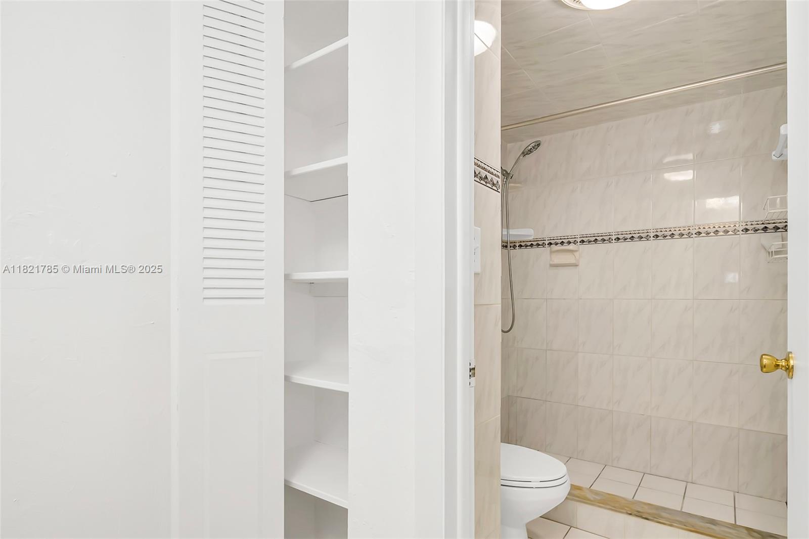 8335 Southwest 72nd Avenue, Unit 315D Miami, FL 33143 - Photo 25 of 28 a bathroom with a shower and a toilet