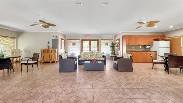 a living room with furniture and a open kitchen view