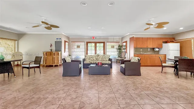 a living room with furniture and a open kitchen view