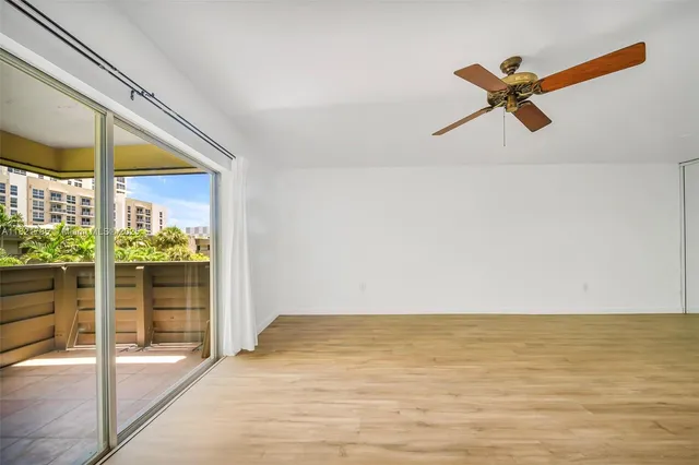 a view of a room with wooden floor and windows