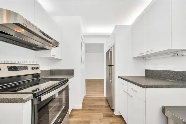 a kitchen with stainless steel appliances granite countertop a sink and a stove