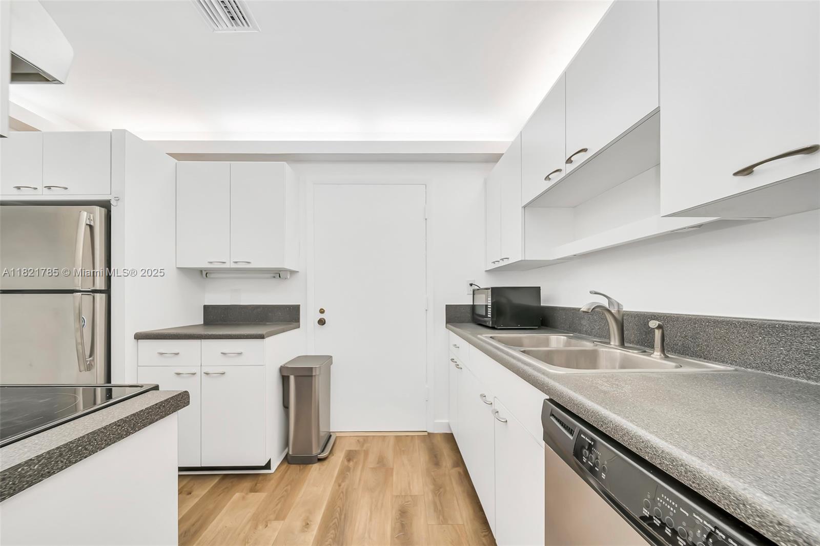 8335 Southwest 72nd Avenue, Unit 315D Miami, FL 33143 - Photo 10 of 28 a kitchen with stainless steel appliances a sink a stove and a refrigerator