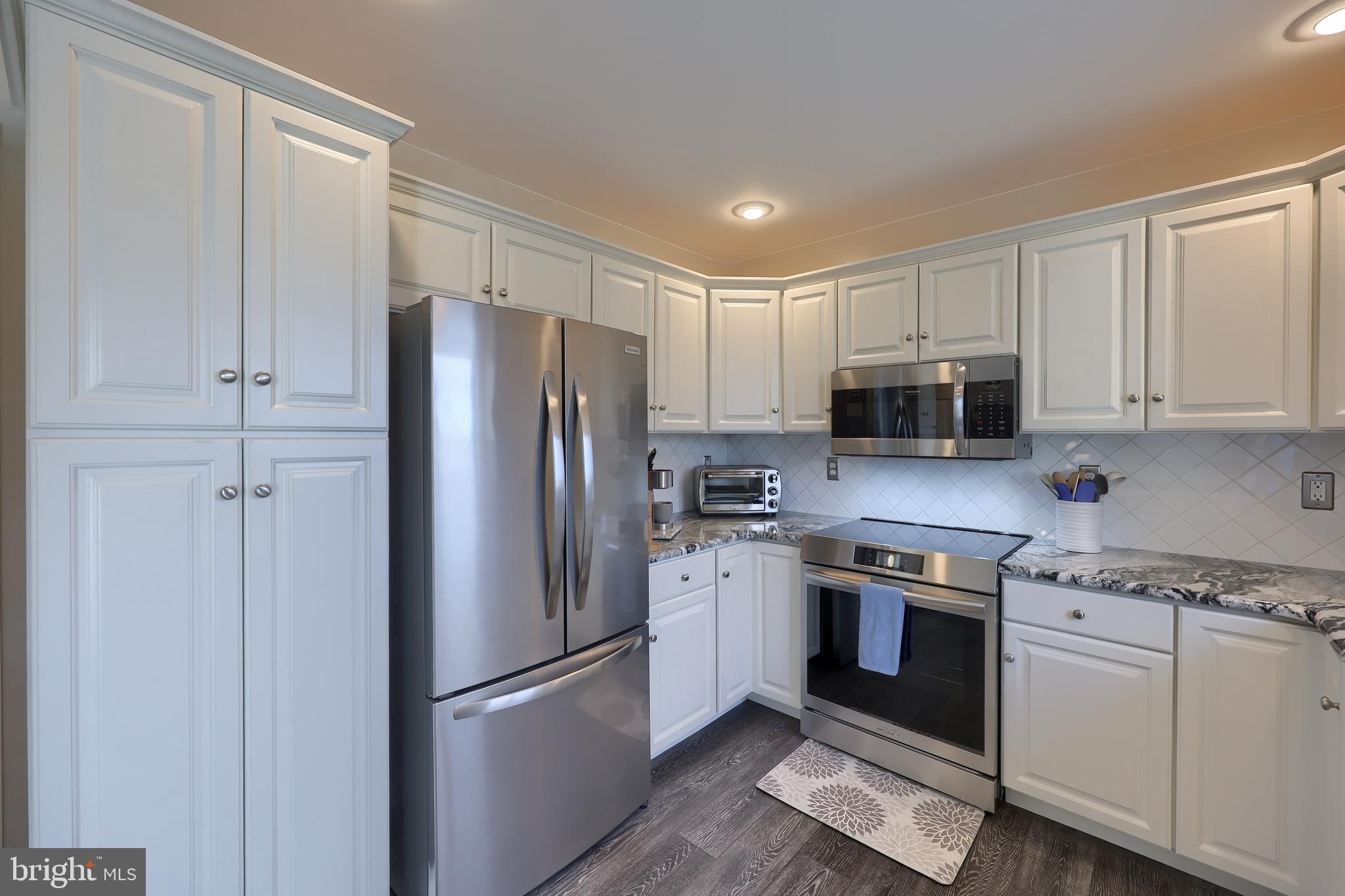 35 Field Lane Lititz, PA 17543 - Photo 17 of 49 a kitchen with cabinets stainless steel appliances and wooden floor