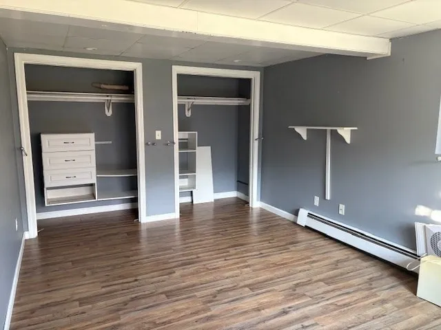 a view of empty room with wooden floor