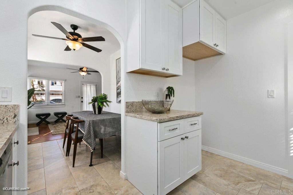 1453-1455 Thomas Avenue San Diego, CA 92109 - Photo 14 of 37 a kitchen with stainless steel appliances granite countertop a sink a stove and a refrigerator