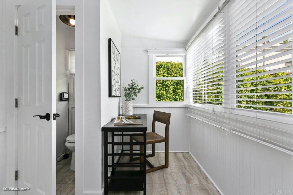 1453-1455 Thomas Avenue San Diego, CA 92109 - Photo 16 of 37 a view of a dining room with furniture window and wooden floor