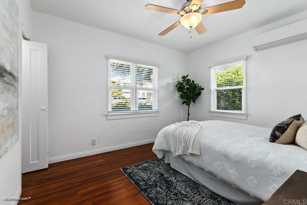1453-1455 Thomas Avenue San Diego, CA 92109 - Photo 17 of 37 a bedroom with a bed and a window
