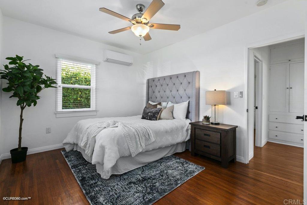 1453-1455 Thomas Avenue San Diego, CA 92109 - Photo 18 of 37 a bed room with a bed and a chandelier