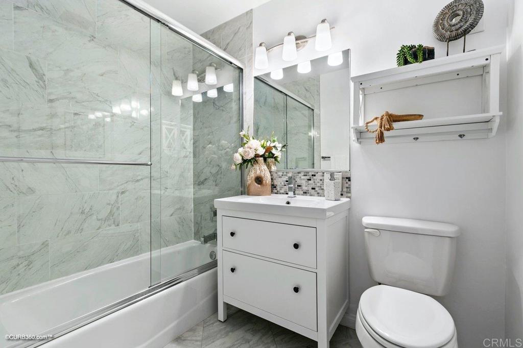 1453-1455 Thomas Avenue San Diego, CA 92109 - Photo 20 of 37 a bathroom with a sink a toilet and shower