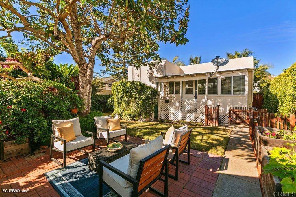 1453-1455 Thomas Avenue San Diego, CA 92109 - Photo 23 of 37 a view of a patio with table and chairs and potted plants