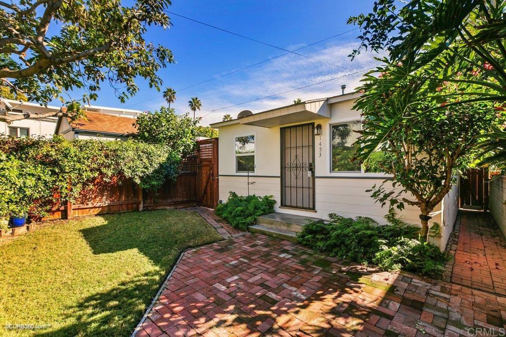 1453-1455 Thomas Avenue San Diego, CA 92109 - Photo 26 of 37 a front view of a house with garden