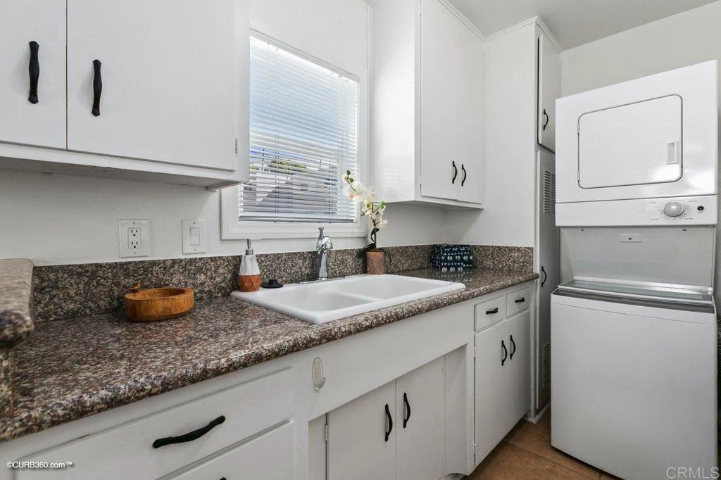 1453-1455 Thomas Avenue San Diego, CA 92109 - Photo 31 of 37 a kitchen with granite countertop white cabinets and a sink